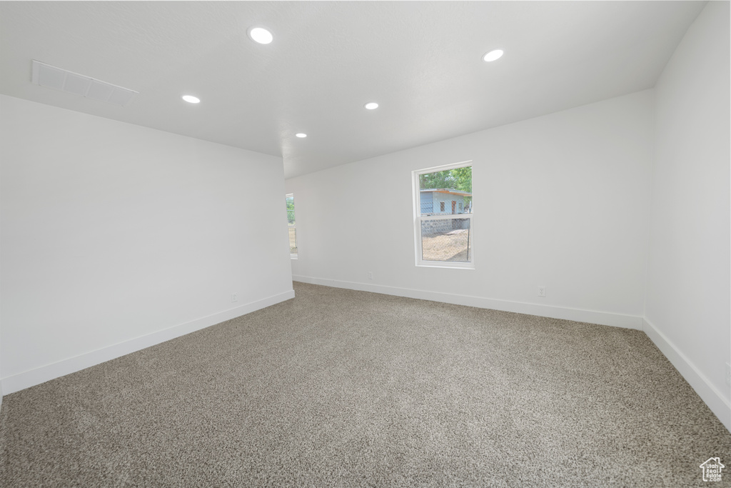Unfurnished room featuring recessed lighting, healthy amount of natural light, and carpet floors