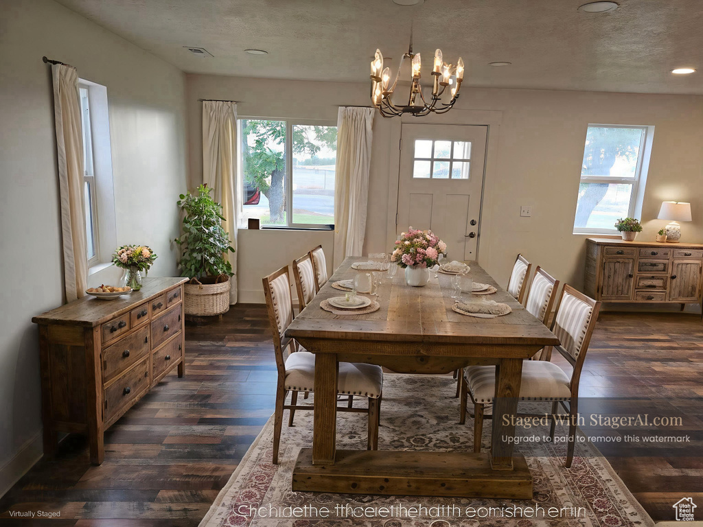 Dining area with dark wood finished floors, a chandelier, and recessed lighting