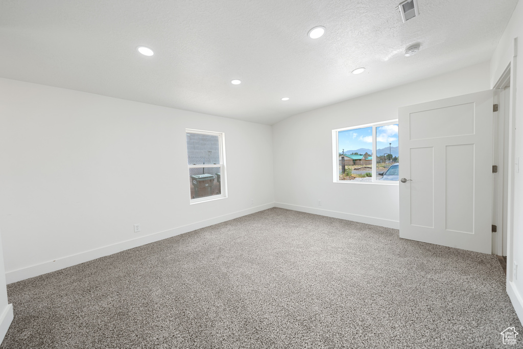 Unfurnished room with recessed lighting and light colored carpet