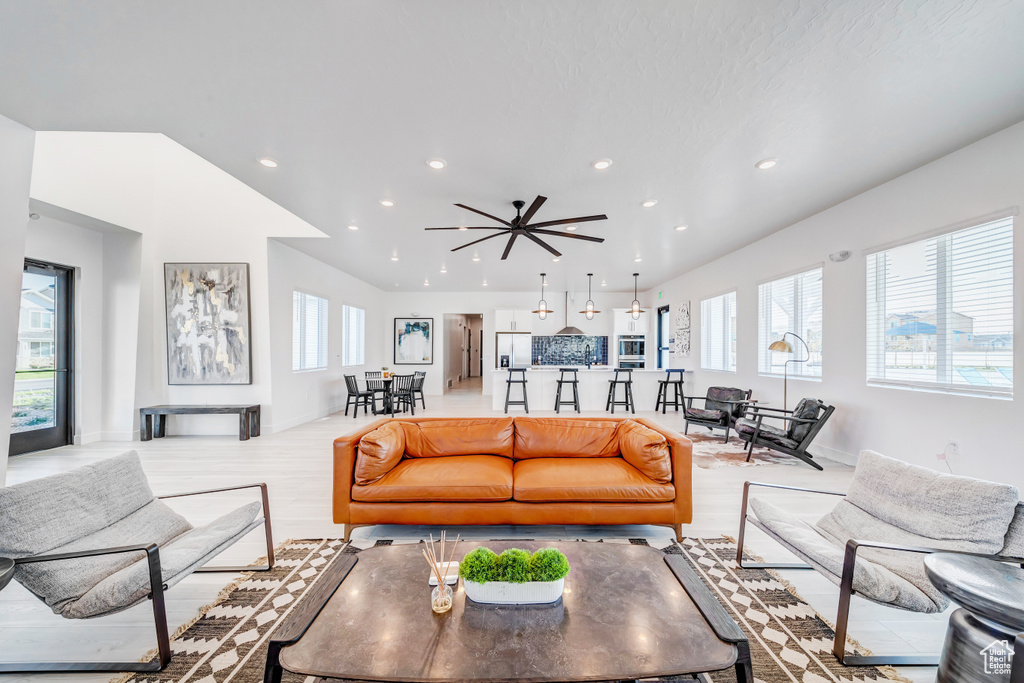 Living room with wood finished floors, a wealth of natural light, and recessed lighting