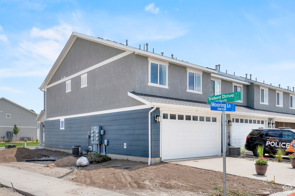 View of front facade featuring a garage and concrete driveway