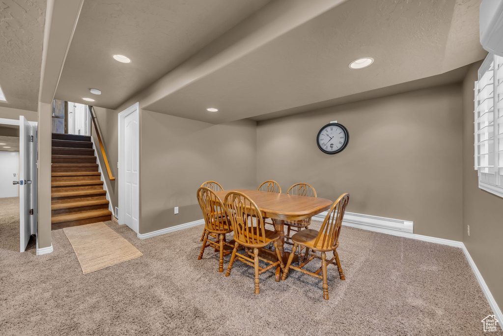 Dining room featuring carpet flooring, baseboards, stairs, and recessed lighting