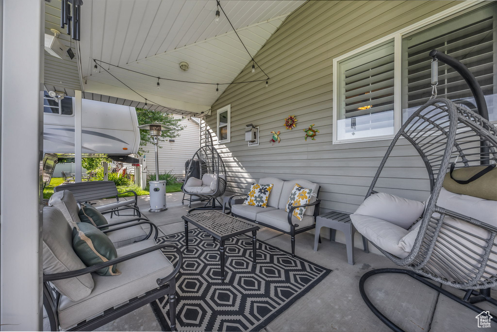 View of patio with an outdoor hangout area