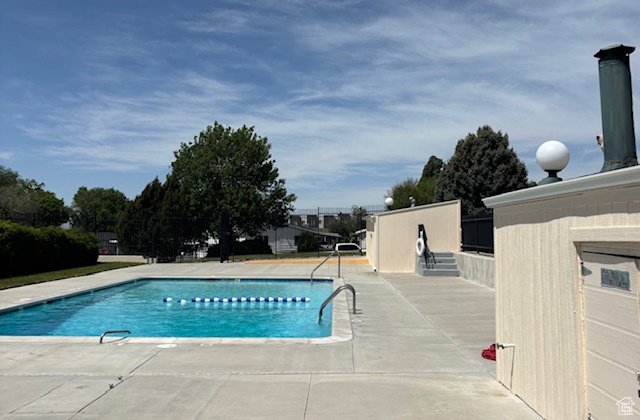 Community pool with a patio