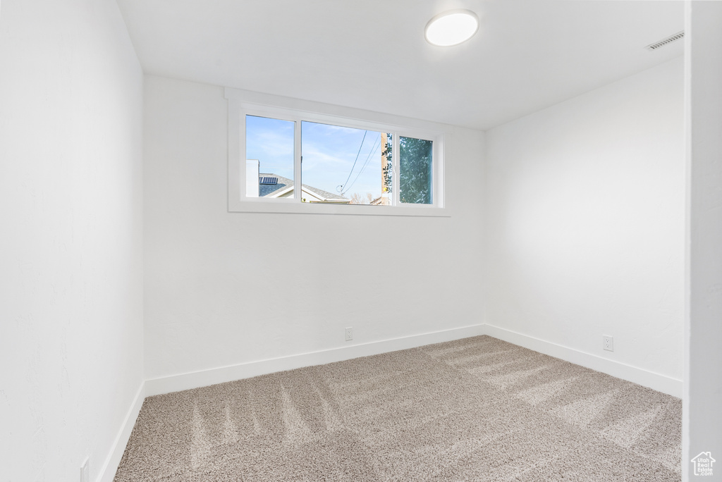 Empty room with carpet and baseboards
