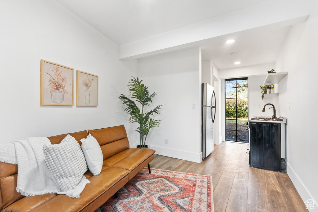 Living area featuring light wood-style flooring, baseboards, and recessed lighting