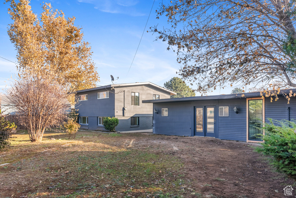 Rear view of property with french doors