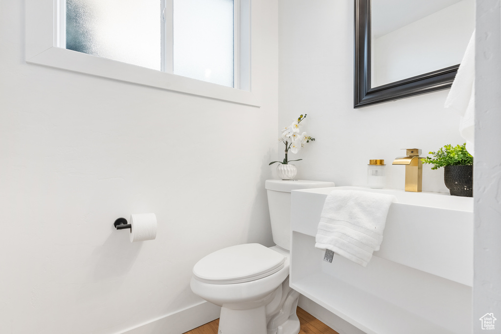 Bathroom featuring toilet and wood finished floors