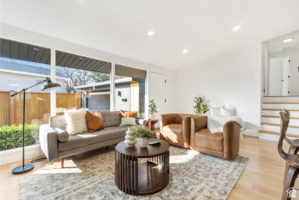 Living area featuring wood finished floors, plenty of natural light, and recessed lighting