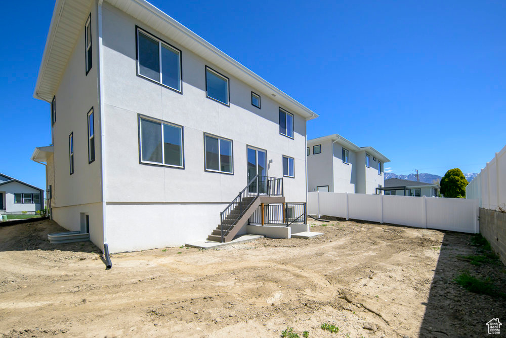 Rear view of house with stucco siding