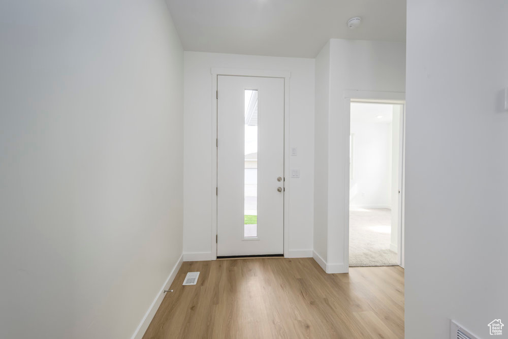 Entrance foyer featuring light wood-type flooring and baseboards