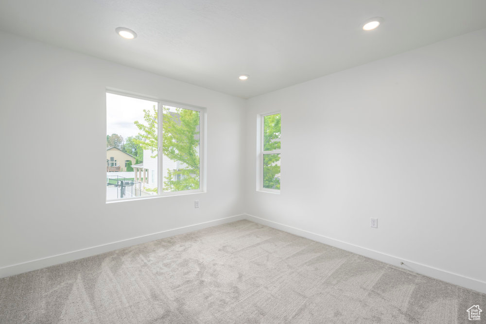 Spare room with carpet flooring, baseboards, and recessed lighting
