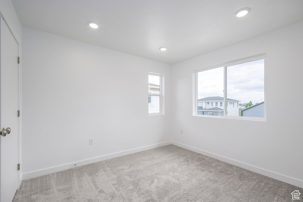 Unfurnished room with carpet, baseboards, and recessed lighting