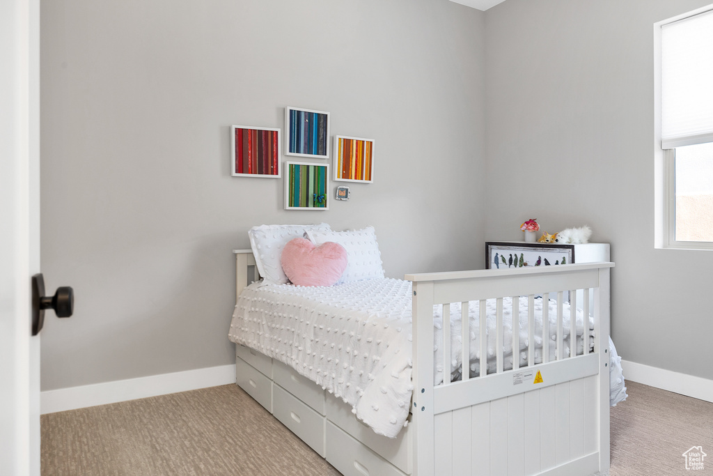 Bedroom featuring baseboards and carpet floors