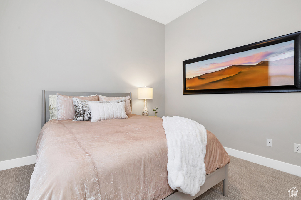 Carpeted bedroom featuring baseboards