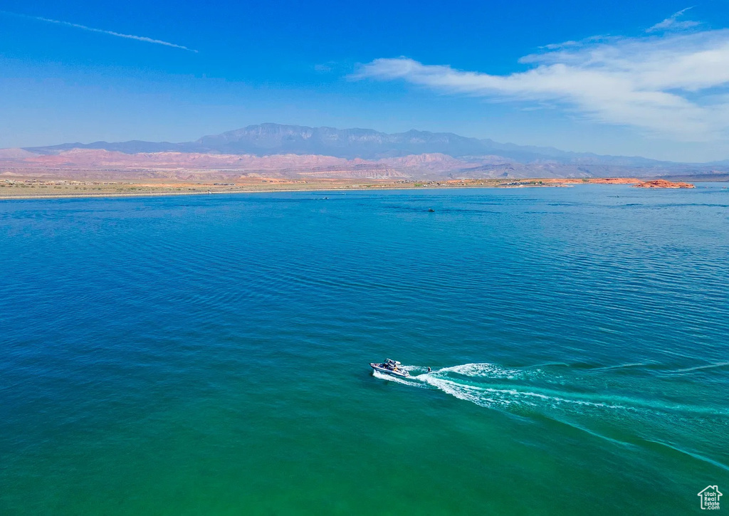 Birds eye view of property featuring a water and mountain view