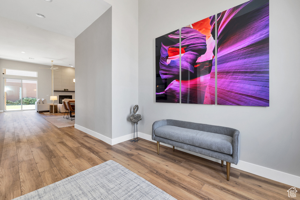 Sitting room featuring baseboards, recessed lighting, wood finished floors, and a fireplace