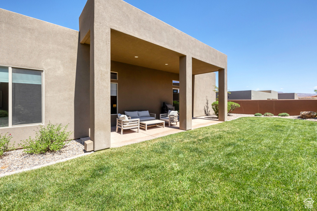 View of yard with outdoor lounge area, fence, and a patio area