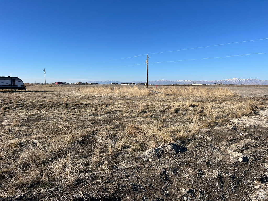 View of local wilderness featuring a rural view and a mountain view