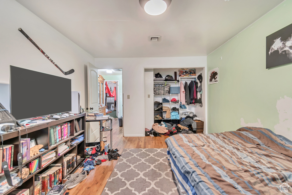 Bedroom featuring a closet, visible vents, and wood finished floors