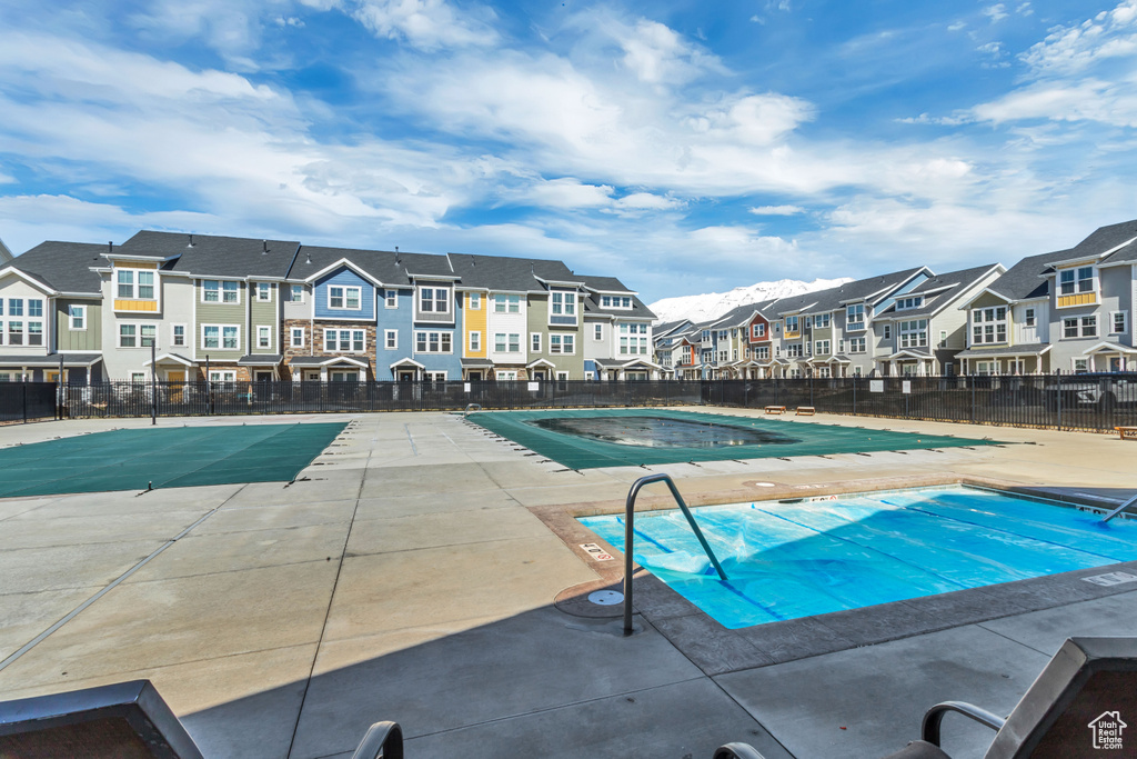 Pool with a residential view, a patio, and fence