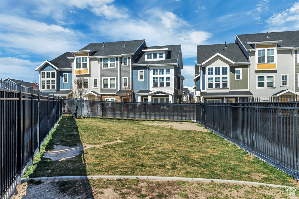 View of yard with a fenced backyard and a residential view