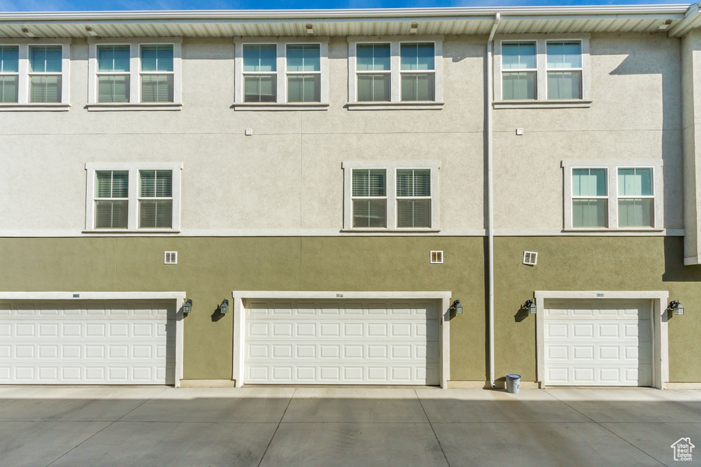 Exterior space featuring an attached garage and stucco siding