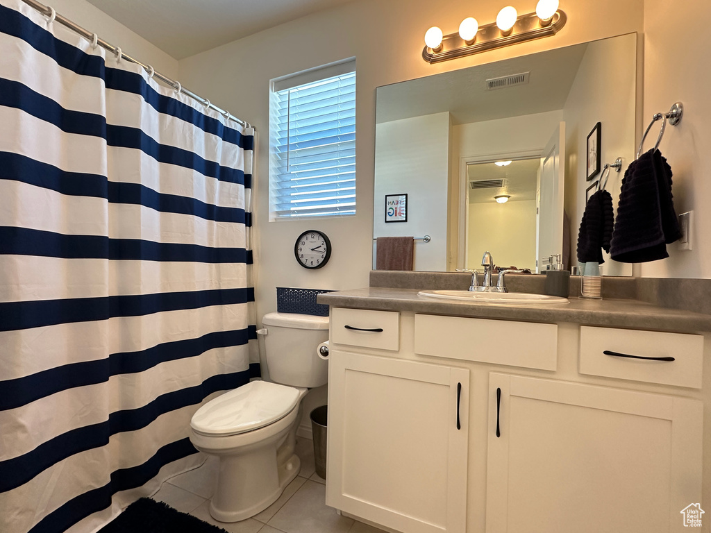 Full bath with visible vents, a shower with shower curtain, toilet, tile patterned flooring, and vanity