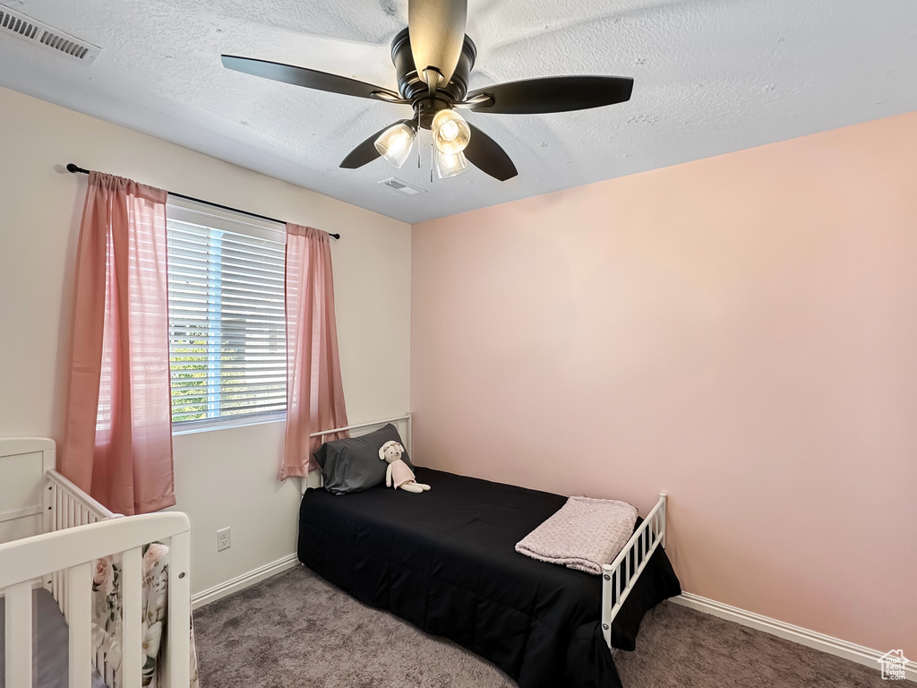 Bedroom featuring ceiling fan, carpet, baseboards, and visible vents
