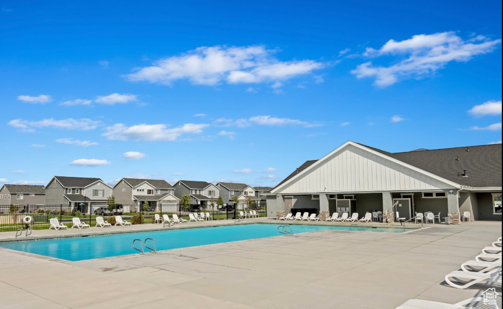 Community pool featuring a residential view and a patio