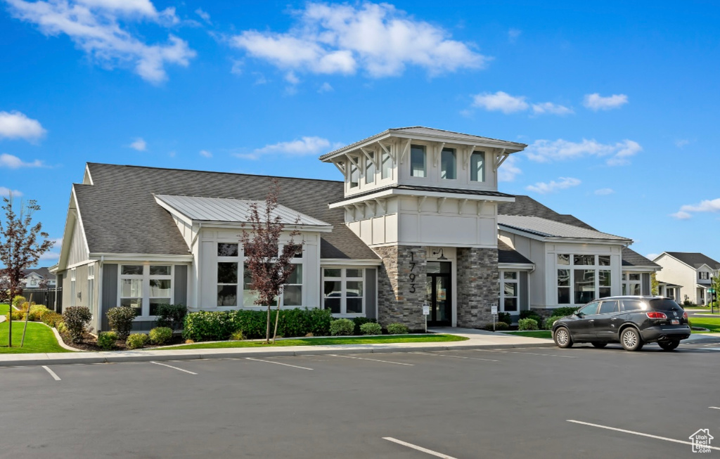 View of building exterior with uncovered parking
