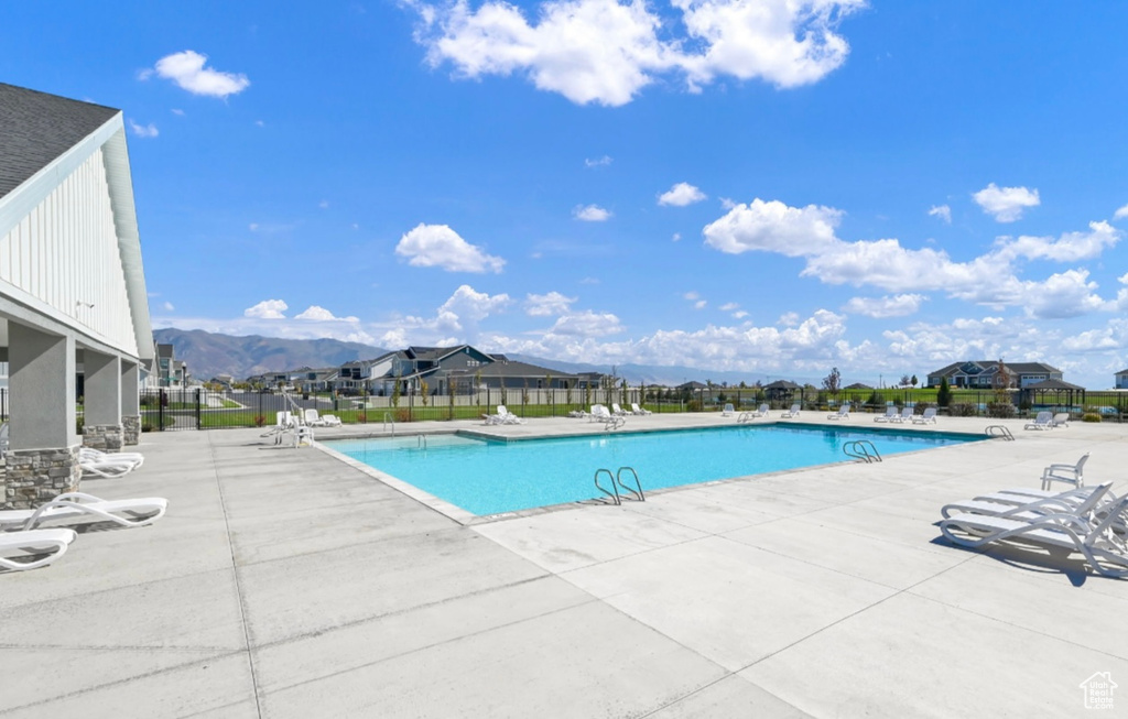 Community pool with a patio area and a mountain view