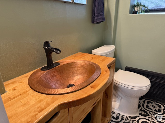 Half bathroom with vanity and toilet