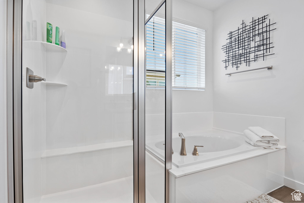 Bathroom with a stall shower and a bath