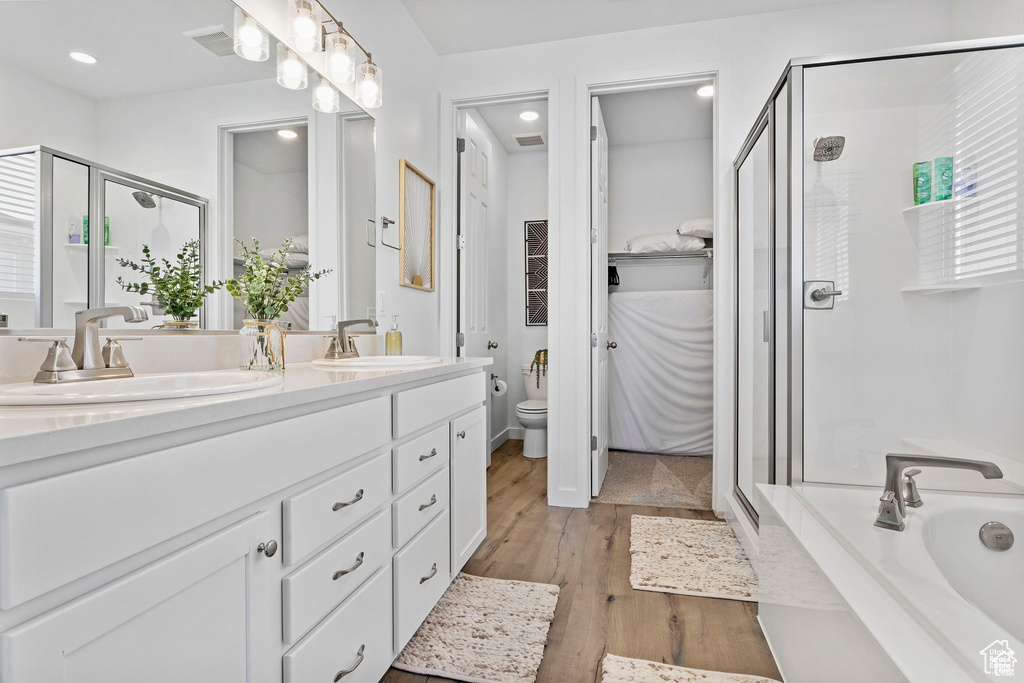 Bathroom with a stall shower, a sink, and toilet