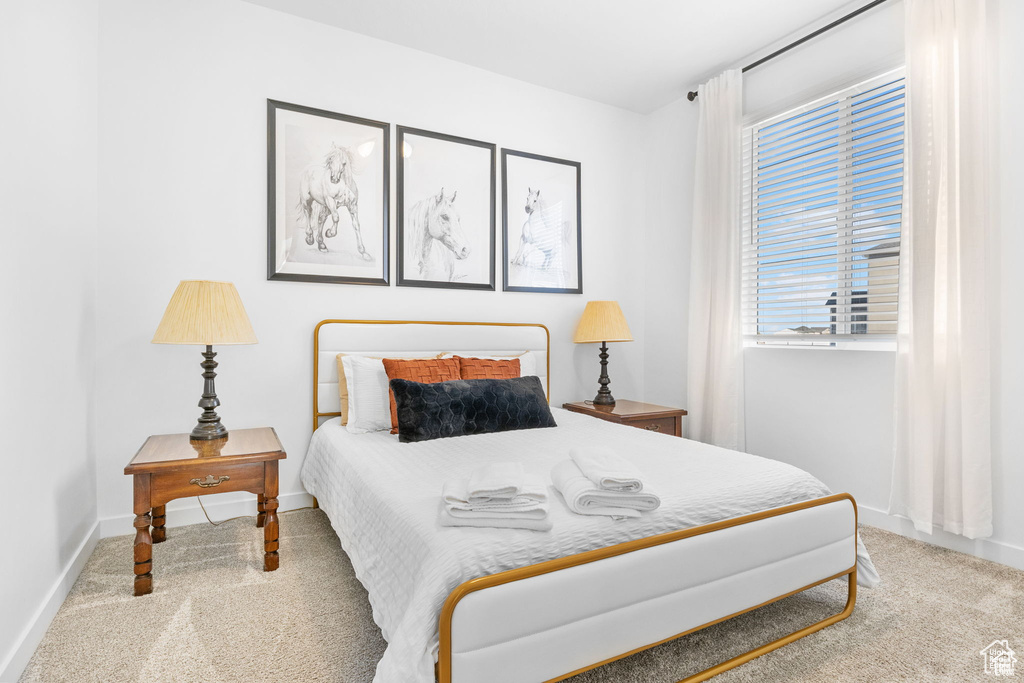 Carpeted bedroom featuring baseboards