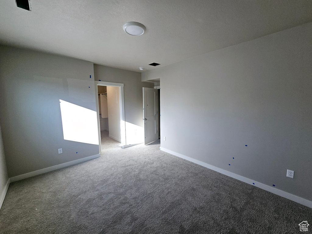 Unfurnished room with light carpet and baseboards