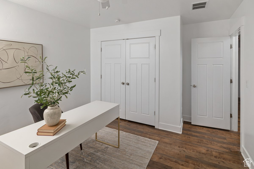 Office featuring dark wood-style floors, visible vents, and baseboards