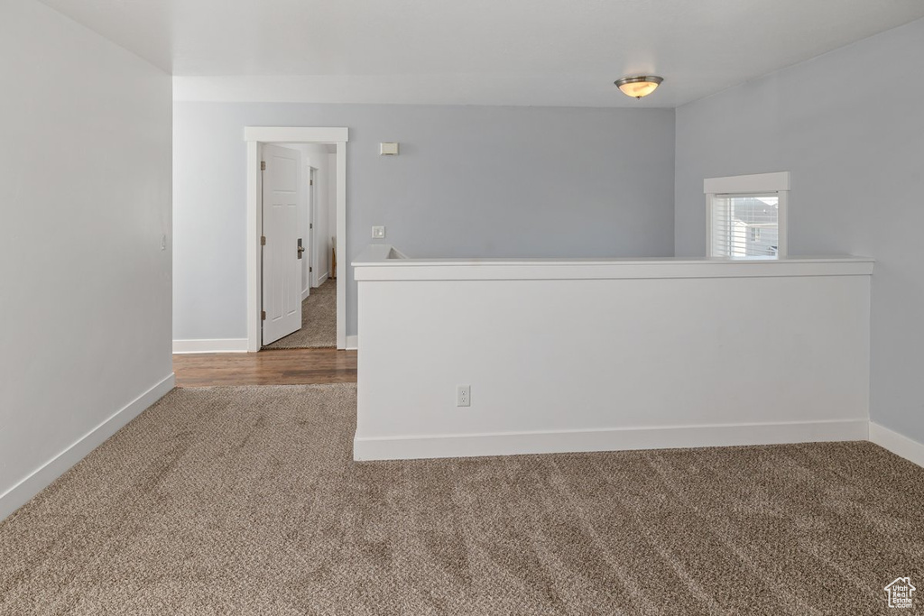 Spare room featuring carpet and baseboards