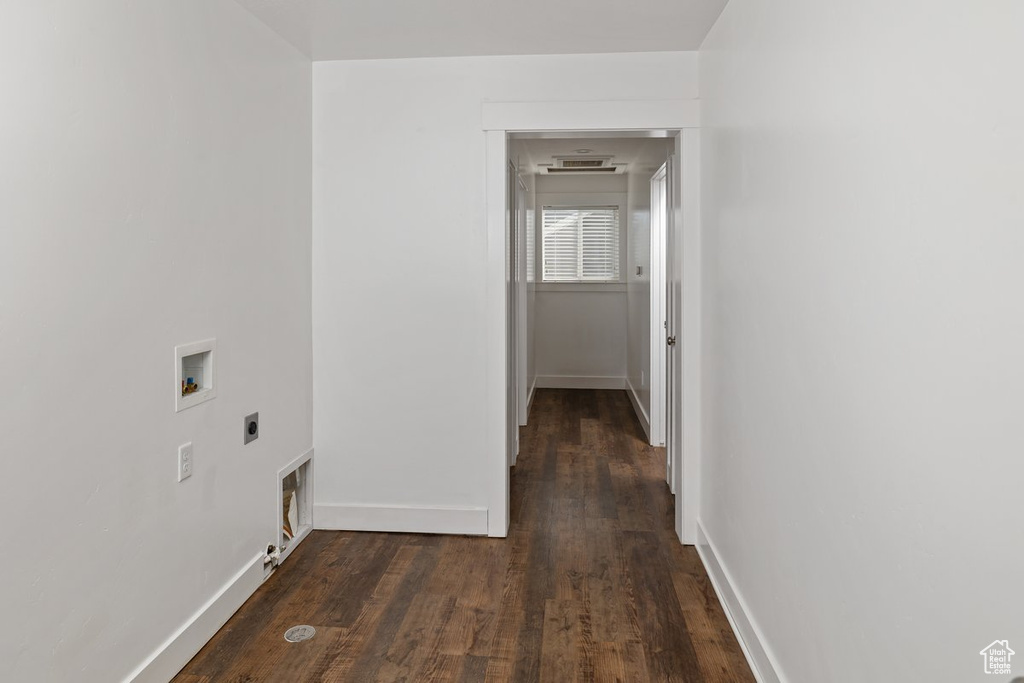 Laundry room featuring dark wood-style floors, baseboards, hookup for a washing machine, and hookup for an electric dryer