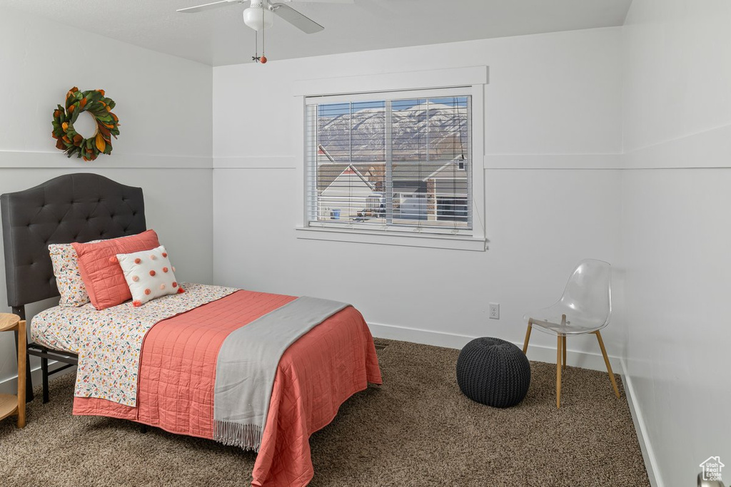 Bedroom with carpet flooring, a ceiling fan, and baseboards