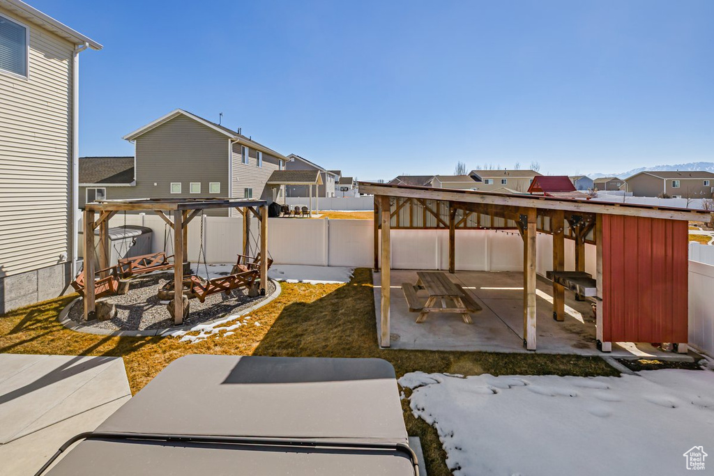 View of patio featuring a fenced backyard, a residential view, and a pergola