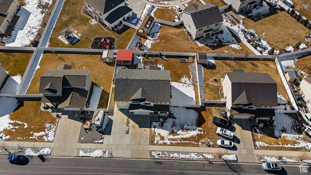 Snowy aerial view featuring a residential view