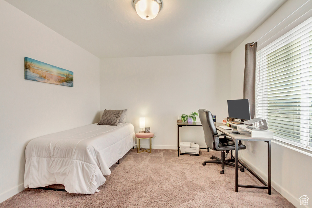 Bedroom with light carpet and baseboards