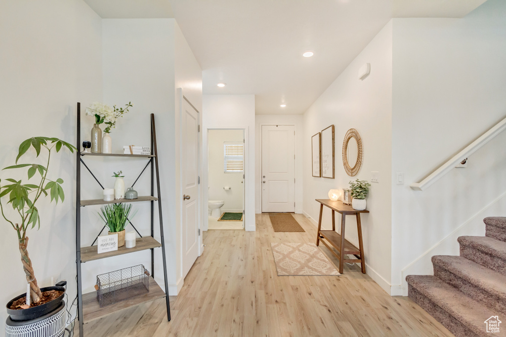 Foyer entrance featuring stairway, recessed lighting, light wood-style flooring, and baseboards