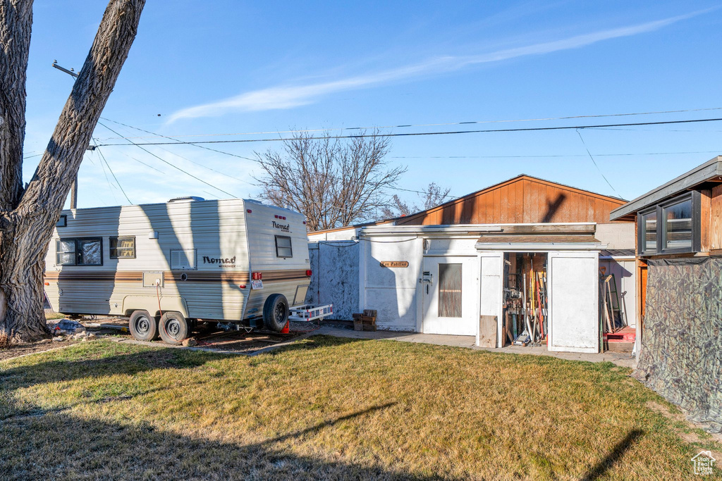 Back of house with a lawn