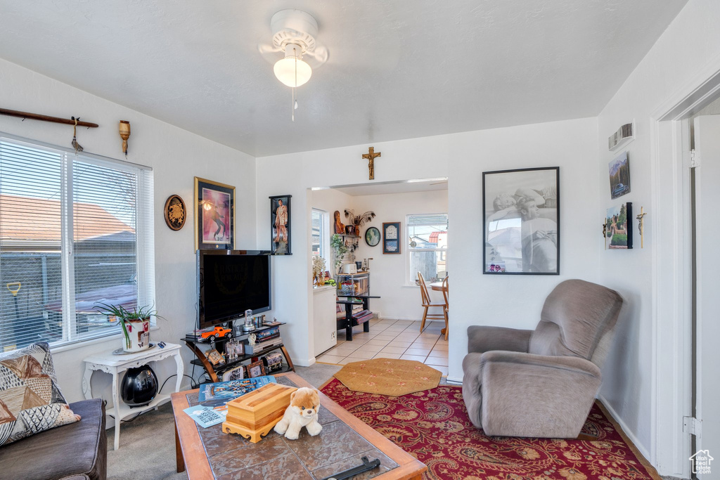 Living room featuring light tile patterned floors and visible vents