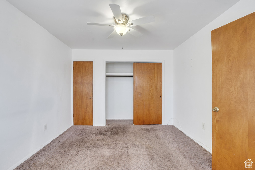 Unfurnished bedroom with carpet and ceiling fan