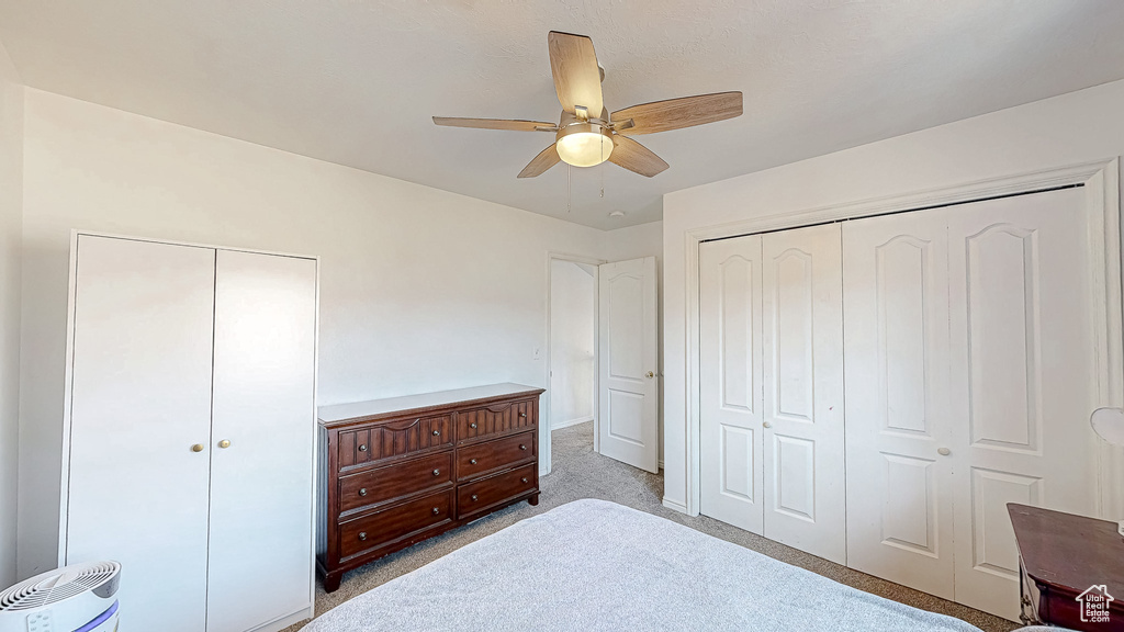 Bedroom featuring ceiling fan and carpet floors