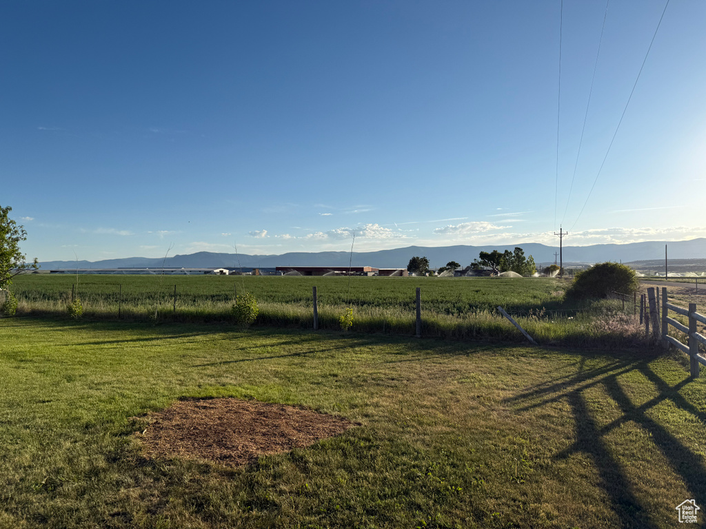 View of yard featuring a rural view and a mountain view